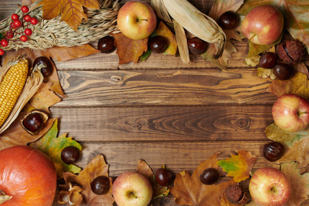 Hello october. autumn background with wheat heads, corn, pumpkin, apples, rowan, chestnuts and...