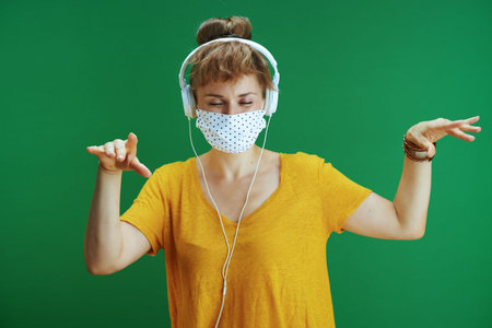 Life during coronavirus pandemic. Closeup on student woman with backpack putting additional medical...