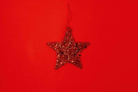flat lay with christmas jingle bells on red background.