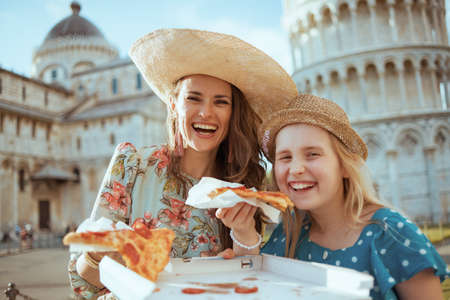 happy modern family with map near Pisa Cathedral.の写真素材