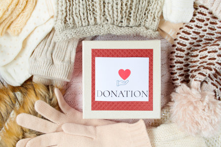 winter flat lay with snowflake, mittens, hats and winter clothes on white knitted background.の写真素材