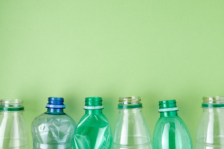 flat lay with plastic bottles isolated on green.