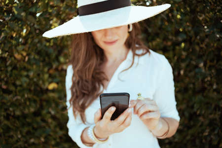smiling elegant middle aged woman in white shirt on the farm.の写真素材