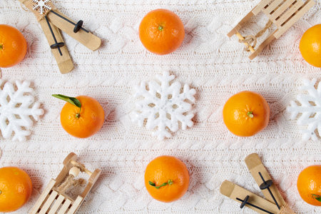 winter flat lay with medical mask, pills and mandarins on white knitted background.