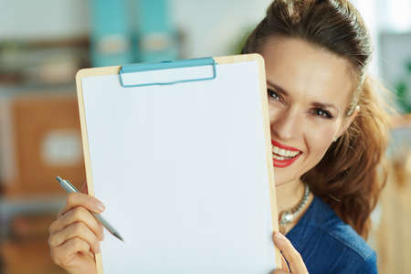 elegant small business owner woman with ffp2 mask, laptop and antiseptic in the office.の写真素材