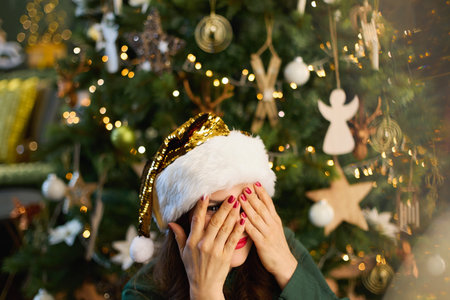Christmas time. Closeup on happy 40 years old housewife with Christmas cookie in traditional...