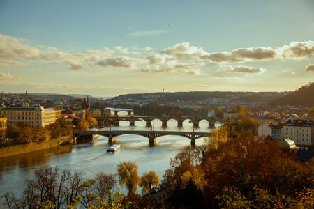 landscape with Vltava river, Karlov bridge and boat in the evening in autumn in Prague, Czech Republic.の写真素材