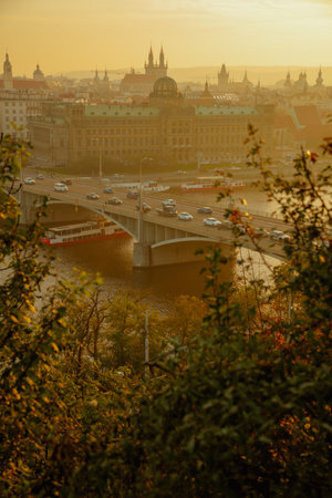landscape with church of our lady before tyn in the evening shot through the foliage in autumn in Prague, Czech Republic.の写真素材