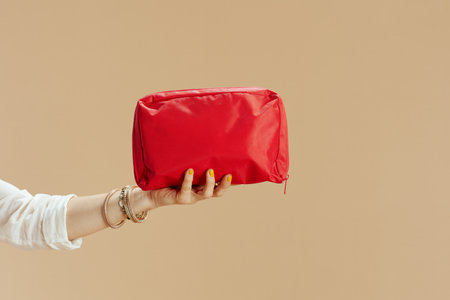 Beach vacation. Closeup on woman isolated on beige background with first aid kit.の写真素材