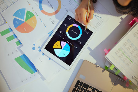 business woman with tablet pc working with documents and graphs.