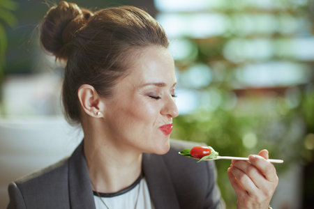 Sustainable workplace. unhappy modern 40 years old accountant woman in a gray business suit in...
