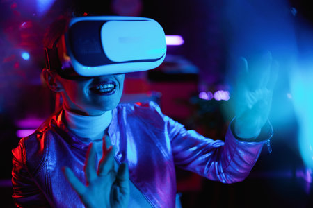 Neon metaverse futuristic concept. happy stylish 40 years old woman in virtual reality goggles...