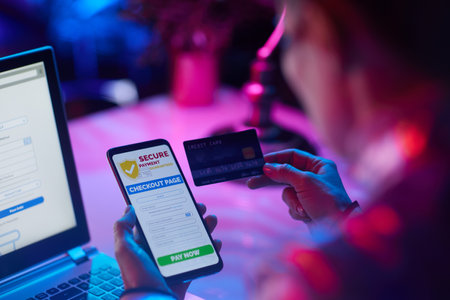 Closeup on modern woman with credit card and smartphone making online shopping on e-commerce website.の写真素材