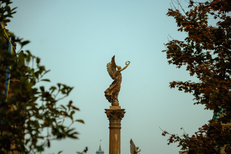 landscape with statue near Rudolfinum concert hall in the evening shot through the foliage in autumn in Prague, Czech Republic.の写真素材