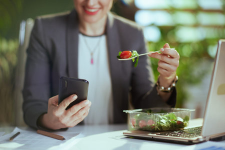 Sustainable workplace. happy modern business woman in a gray business suit in modern green office...