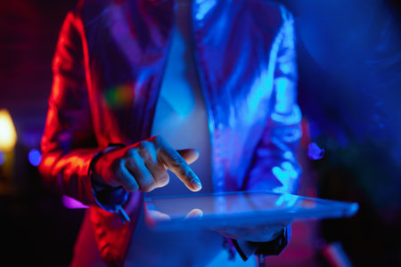 Neon metaverse futuristic concept. Closeup on business woman with tablet PC.の写真素材