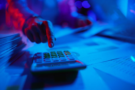 Closeup on modern female with calculator and documents in modern office.の写真素材