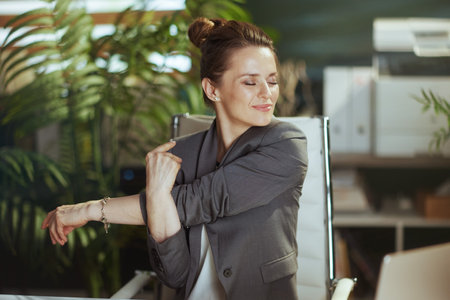 Sustainable workplace. happy modern business woman in modern green office stretching hands.の写真素材