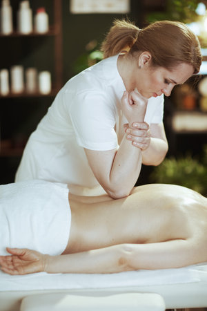 Healthcare time. medical massage therapist in massage cabinet do a massage therapy on massage table.