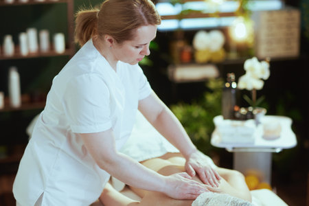 Healthcare time. medical massage therapist in massage cabinet do a massage therapy on massage table.の写真素材