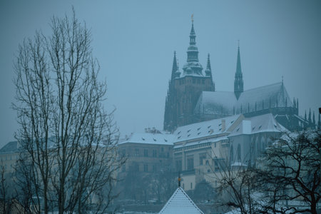 landscape in winter in Prague, Czech Republic with St. Vitus Cathedral in the evening.の写真素材