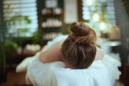 Healthcare time. relaxed modern woman in spa salon laying on massage table.の写真素材