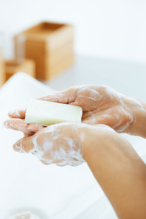 Closeup on young woman's hands with soap barの写真素材