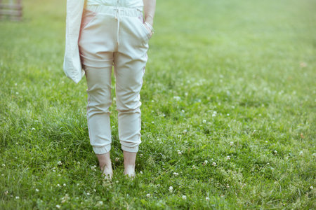Summer time. Closeup on woman in the meadow in the city park.の写真素材