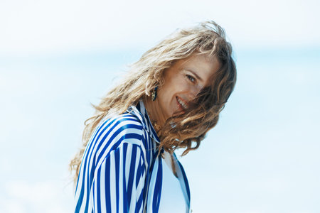 smiling modern female on the seacoast having fun time.