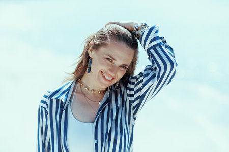 happy stylish middle aged woman on the ocean coast having fun time.の写真素材