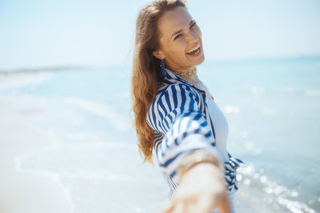 happy modern female on the seacoast having fun time.の写真素材