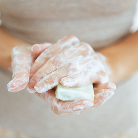Closeup on young woman's hands with soap barの写真素材