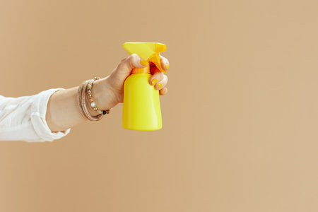 Beach vacation. Closeup on woman isolated on beige background with spf.の写真素材