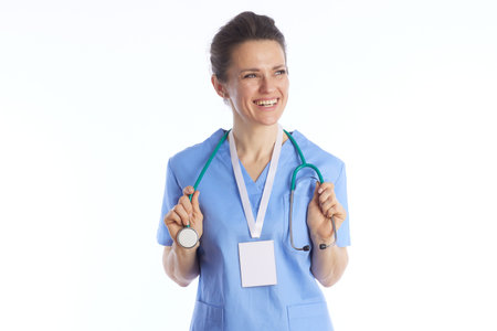 A cheerful female doctor with a green stethoscope around her neck looks away with a smile, symbolizing compassionate care and medical expertise.の写真素材