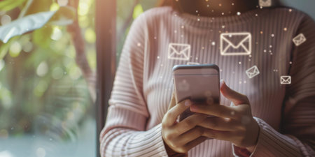 Email concept, Closeup of woman's hand using mobile phone with email icon