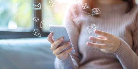Email concept, Closeup of woman's hand using mobile phone with email icon