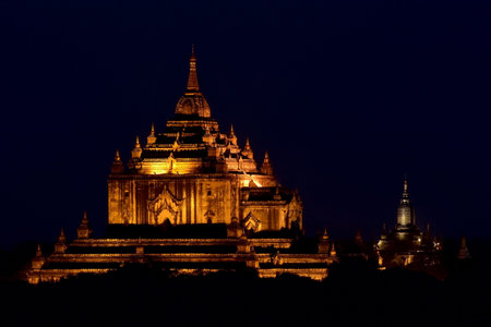 Ancient Gawdawpalin paya in mysterious illumination at dusk in Bagan archaeological zone, Myanmar (Burma).の写真素材