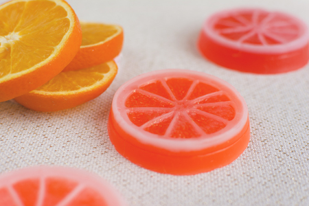 Exclusive orange handmade soaps. Fresh orange slices on the background.の写真素材