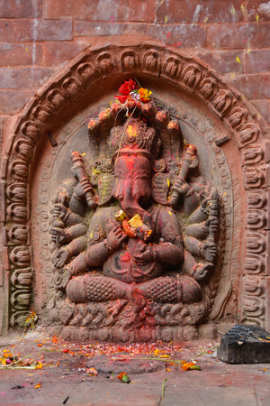 Statue of Lord Ganesha decorated with flowers and fruits in Kathmandu, Nepalの写真素材