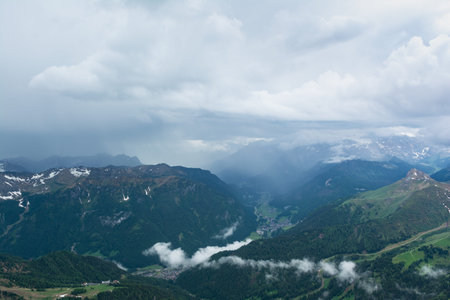 Rain shaft and thunderstorm over Fassa Valley (Val di Fassa). Dolomites Alps, Italy