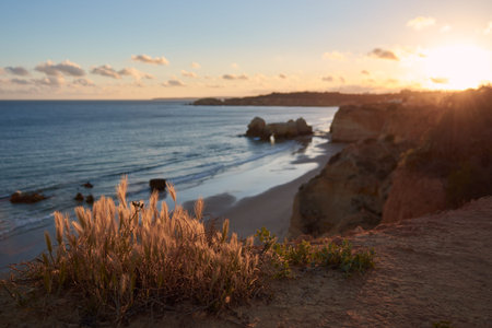 Beautiful sunset over the Praia dos Careanos and Alvor. Algarve region, Portugal