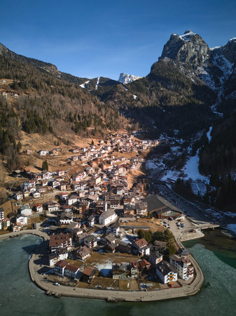 Scenic aerial view of the Alleghe village and Mount Civetta in winter. Dolomite Alps, Italy