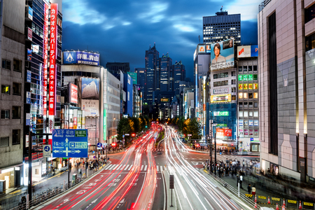Tokyo, Japan - October 16, 2016: Cityscape at night in Shinjuku District with skyscrapers, fast traffic and people on the streetのeditorial素材