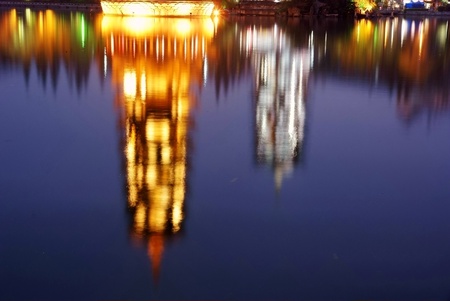 inverted image of chinese ancient towers in water の写真素材