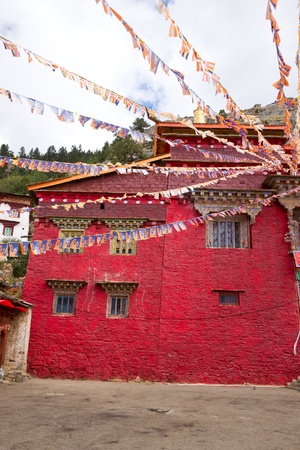 Sutra streamer and temple with red wallの写真素材