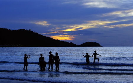 sunset with people in beach          の写真素材
