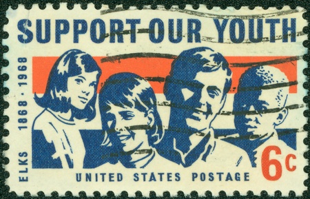 USA - CIRCA 1969  A stamp printed in USA shows a picture of young men and women with the words of Support Our Youth, circa 1969のeditorial素材