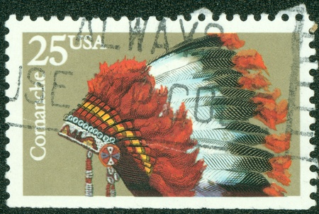 USA - CIRCA 1990  A stamp printed in USA shows the Indian Headdresses of the tribe Comanche, series, circa 1990の写真素材