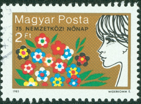 HUNGARY - CIRCA 1985  A stamp printed by Hungary, shows Flowers and Woman, circa 1985のeditorial素材