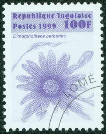 TOGO - CIRCA 1999  A stamp printed in Togo shows the image of a flower , circa 1999のeditorial素材